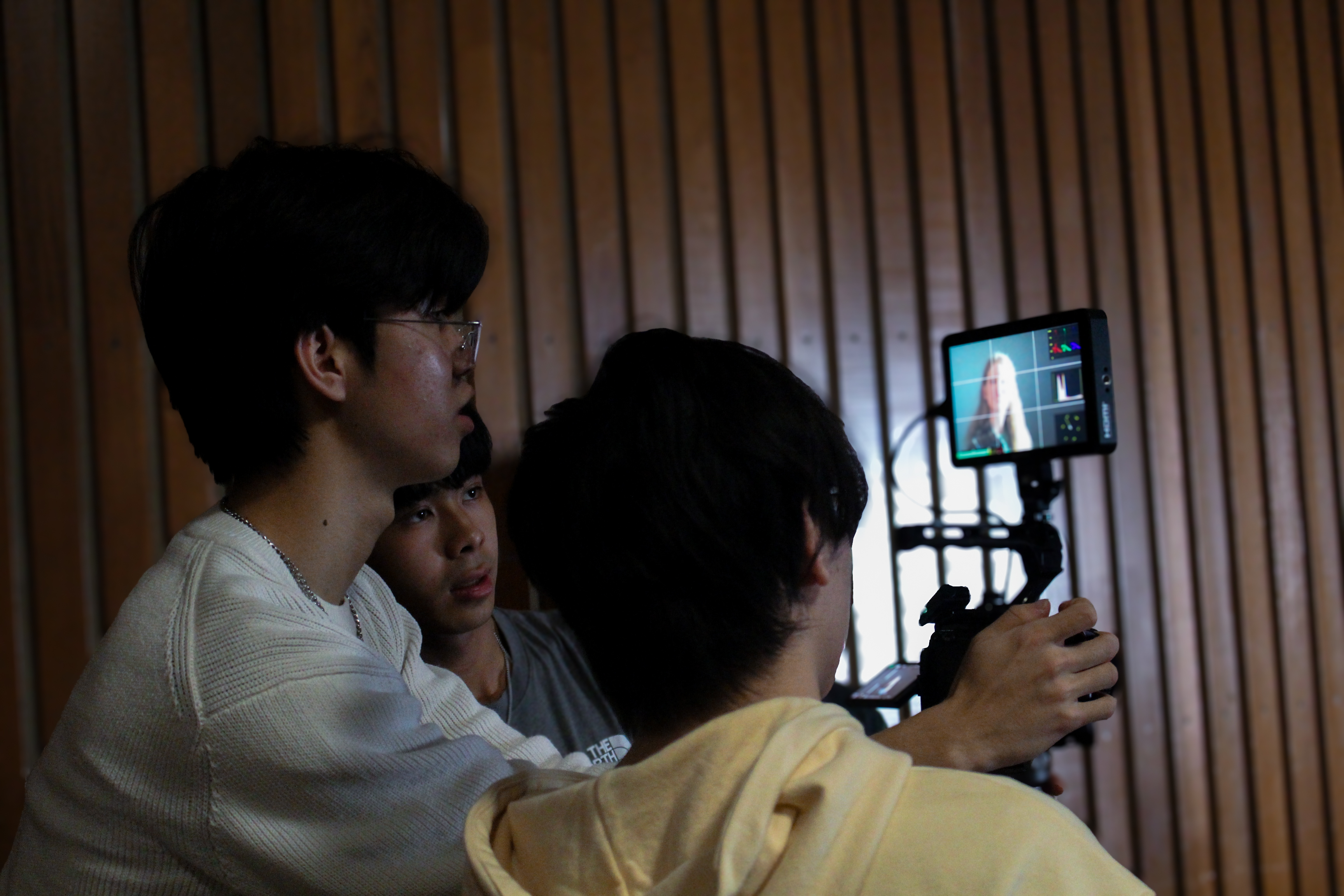 Chadwin Ta working beside a cinema camera rig on set